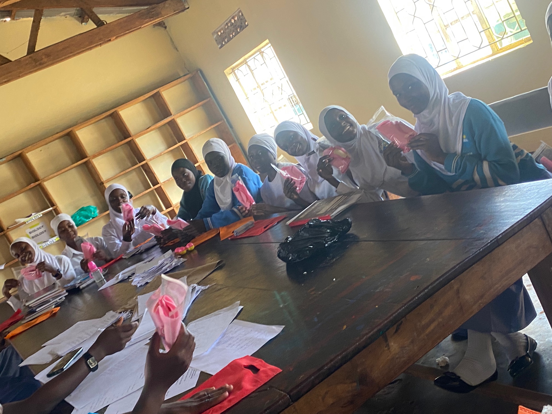 Girls learning to hand-stitch reusable pads